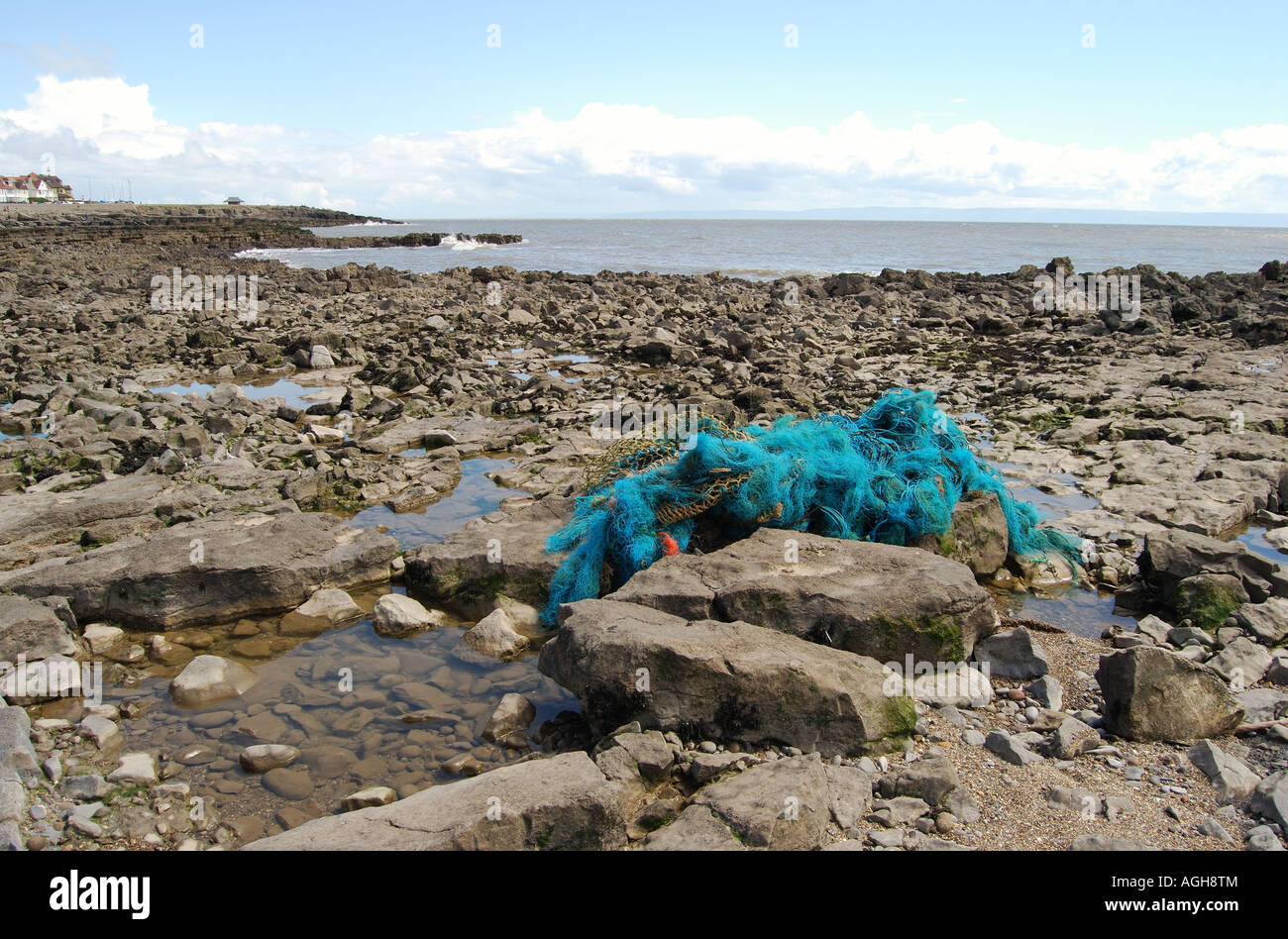 discarded plastic fishing net snagged on rocks number 2519 Stock Photo