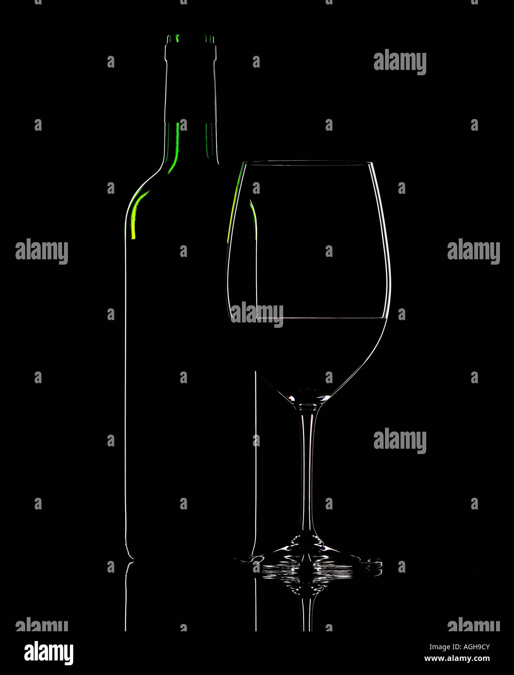 opened red wine bottle and glass on a black background with rim lighting Stock Photo Alamy