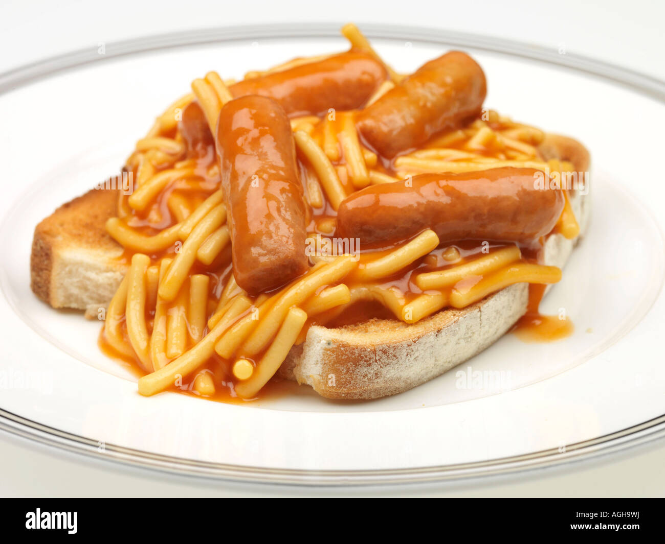 Tin Of Spaghetti Pasta In Tomato Sauce With Pork Sausages On Toast Meal