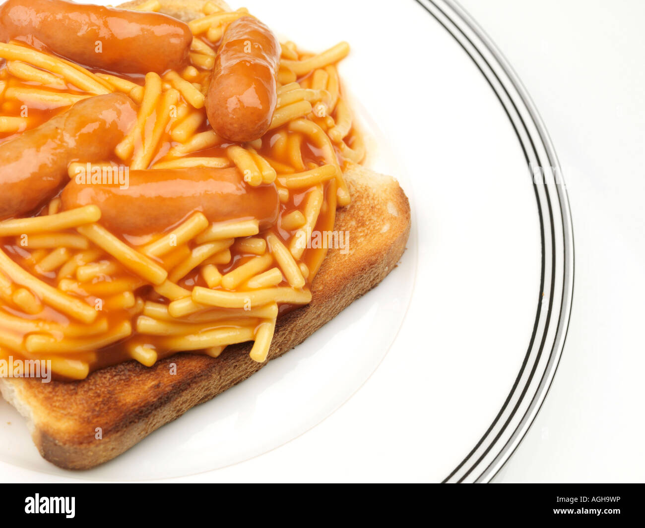 Tin Of Spaghetti Pasta In Tomato Sauce With Pork Sausages On Toast Meal