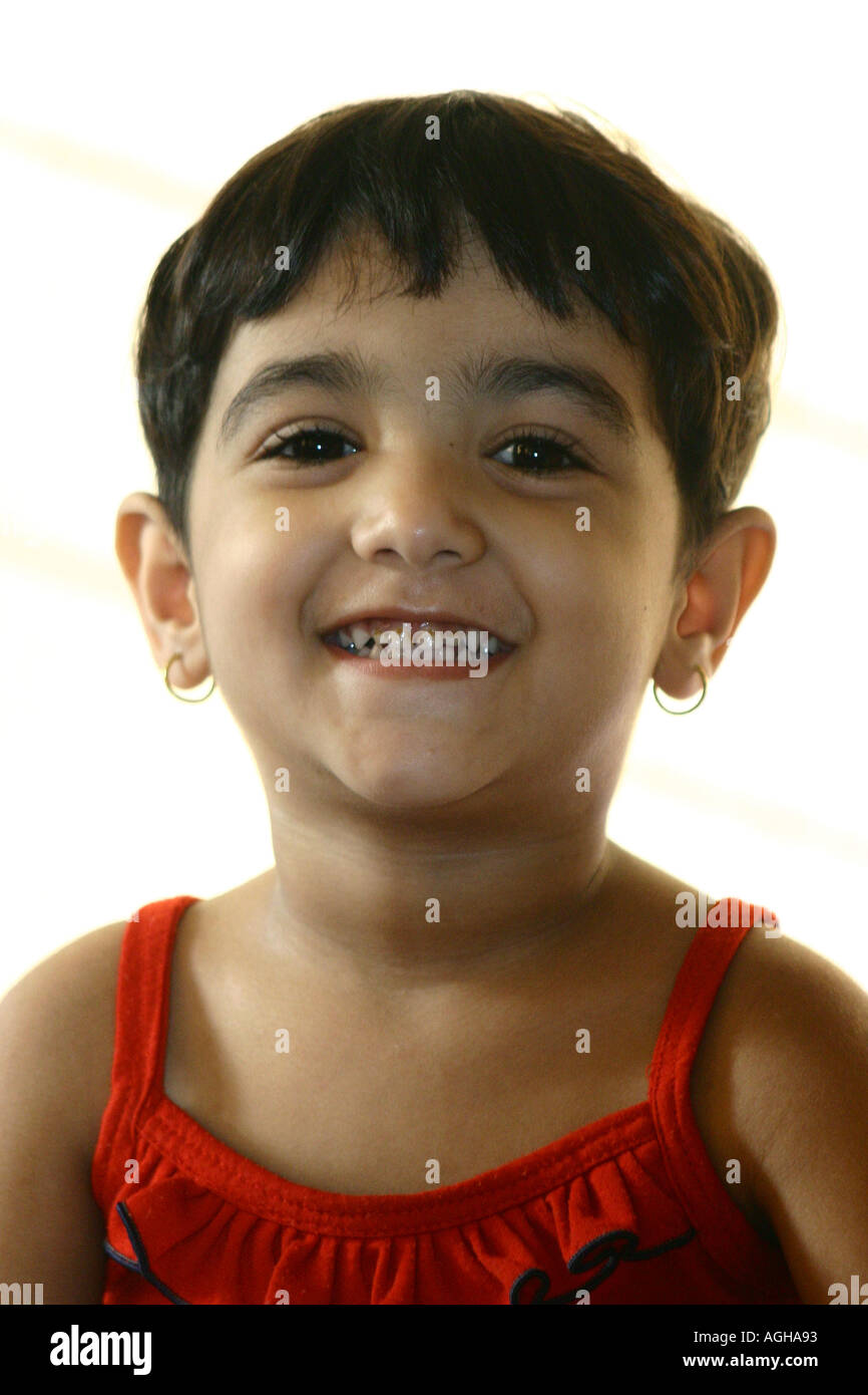 RSC91148 Three years old indian small little baby girl Srishti wearing a  red dress smiling looking into the camera Bombay Stock Photo - Alamy