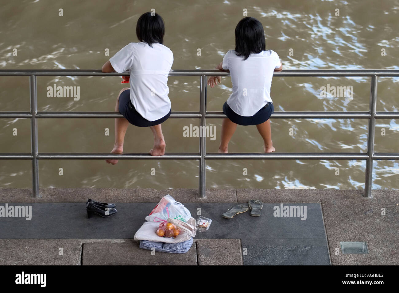 peeing thai girl Schoolgirls sitting on railings by Chao Phraya. Bangkok, Thailand Stock  Photo - Alamy