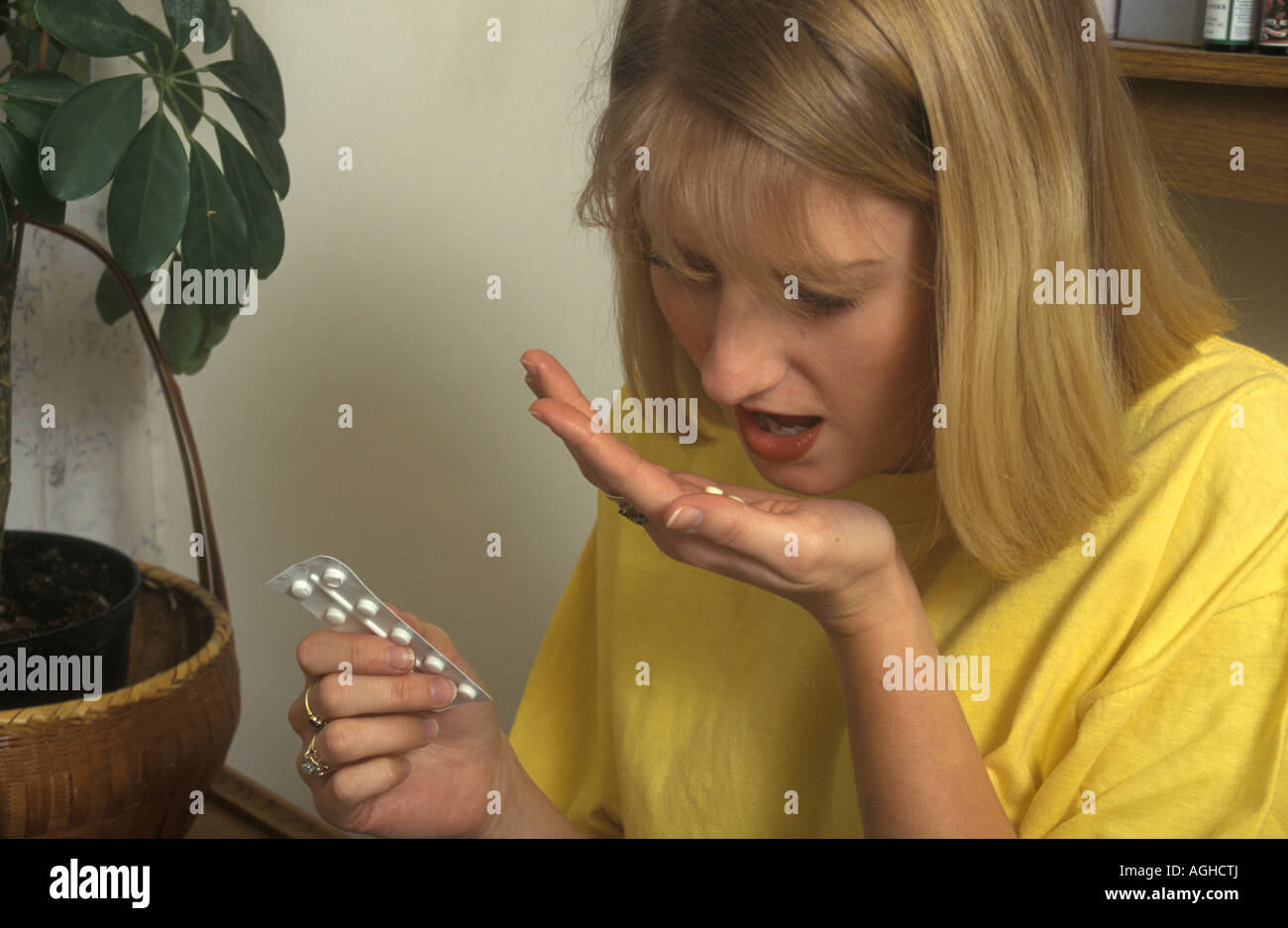 teenage girl taking pills Stock Photo