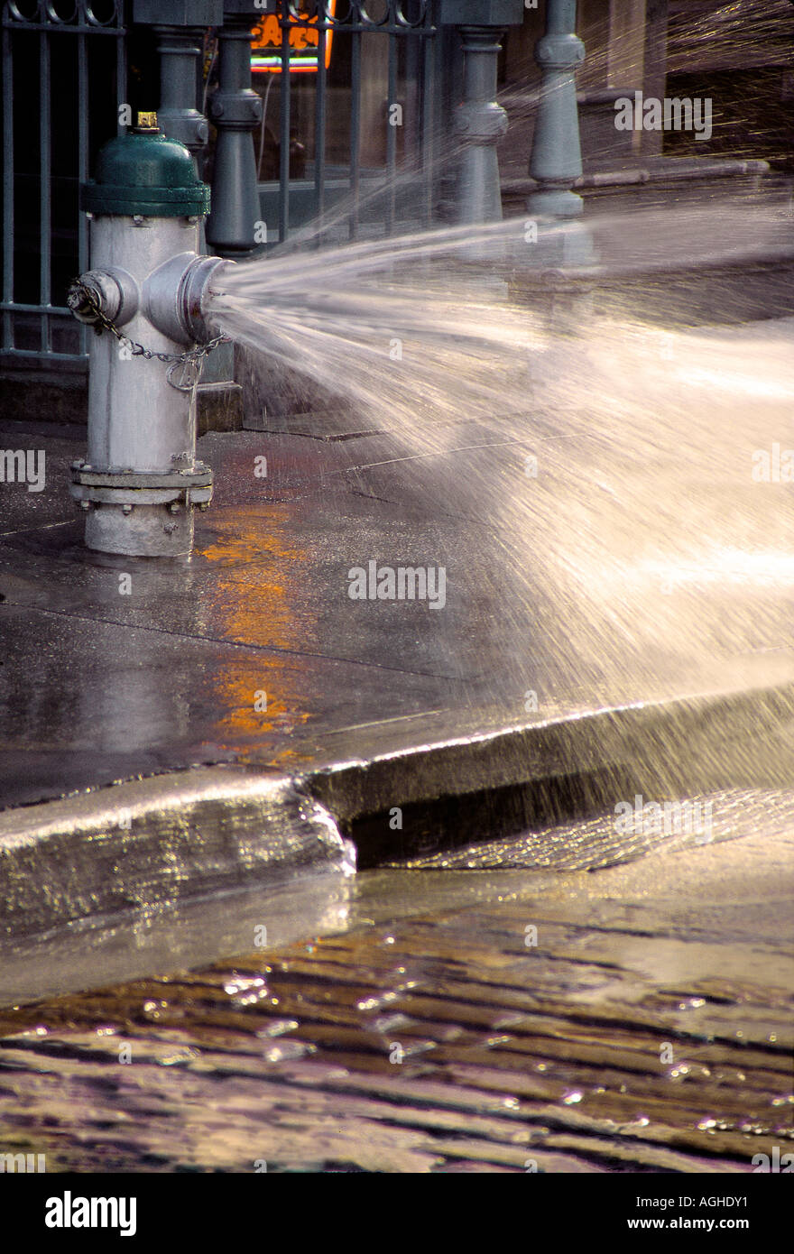A fire hydrant shooting water into the city streets Stock Photo Alamy
