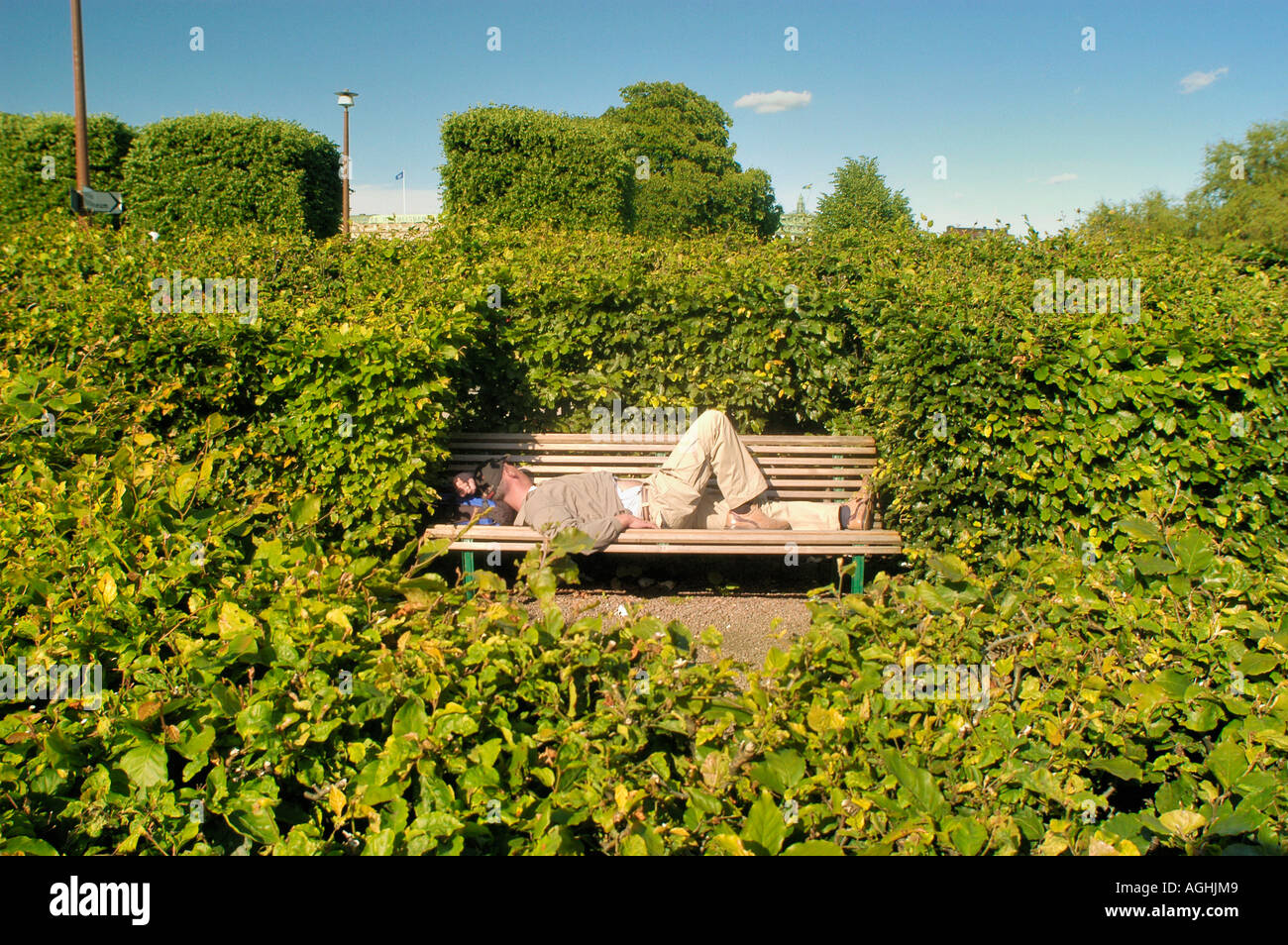 Homeless rests on bench, Skeppsbro, Stockholm, Sweden Stock Photo Alamy