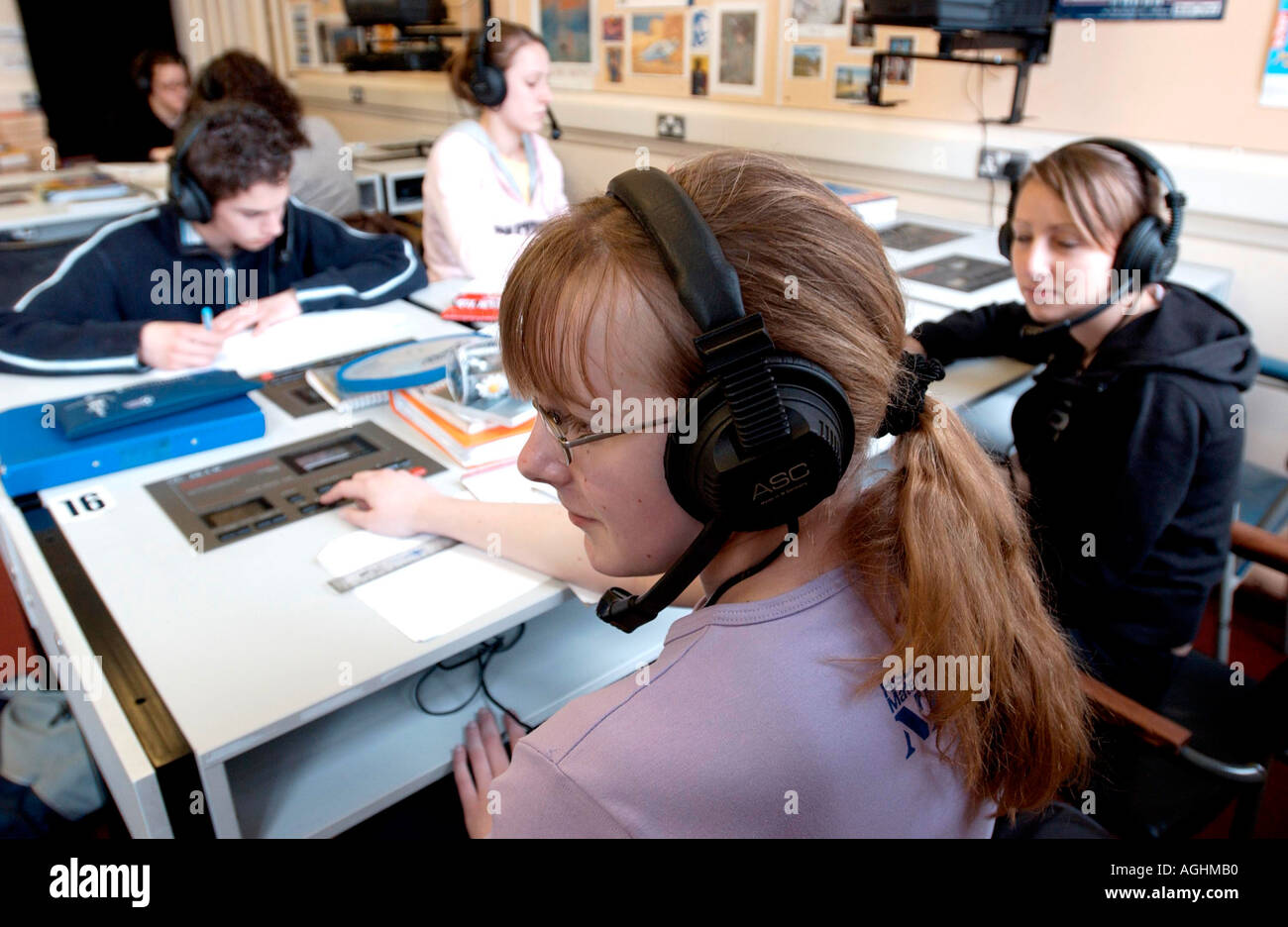 Teenage girl in language laboratory concentrating on Spanish lesson