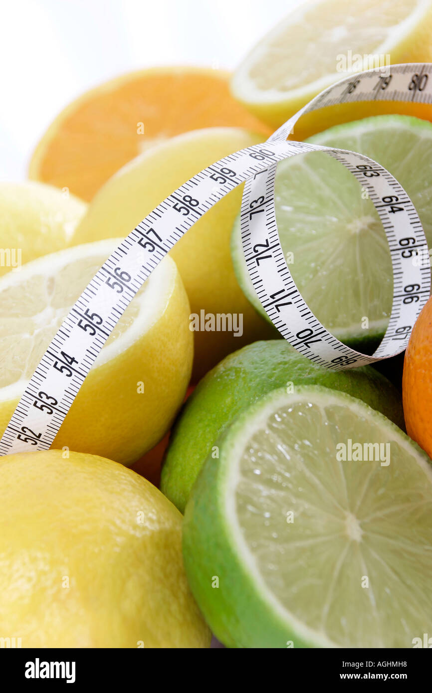 Oranges limes and lemons wrapped with measuring tape Stock Photo