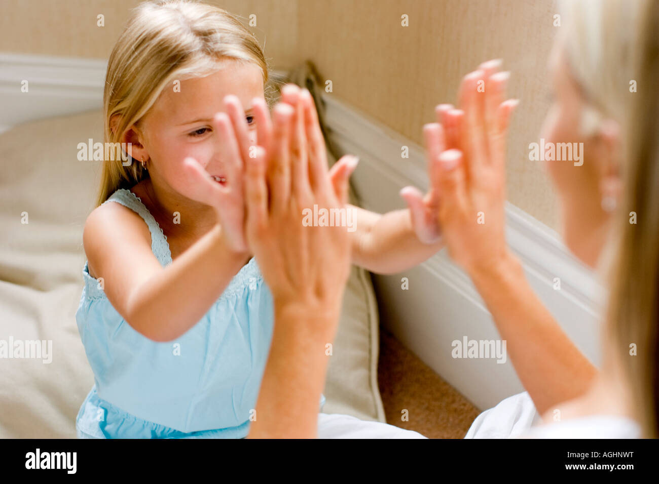 mother and daughter playing pat a cake Stock Photo