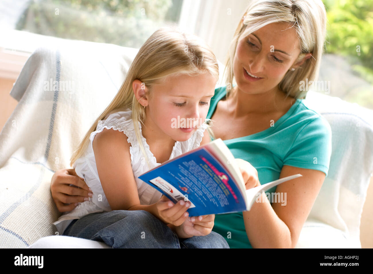 daughter reading to mother Stock Photo