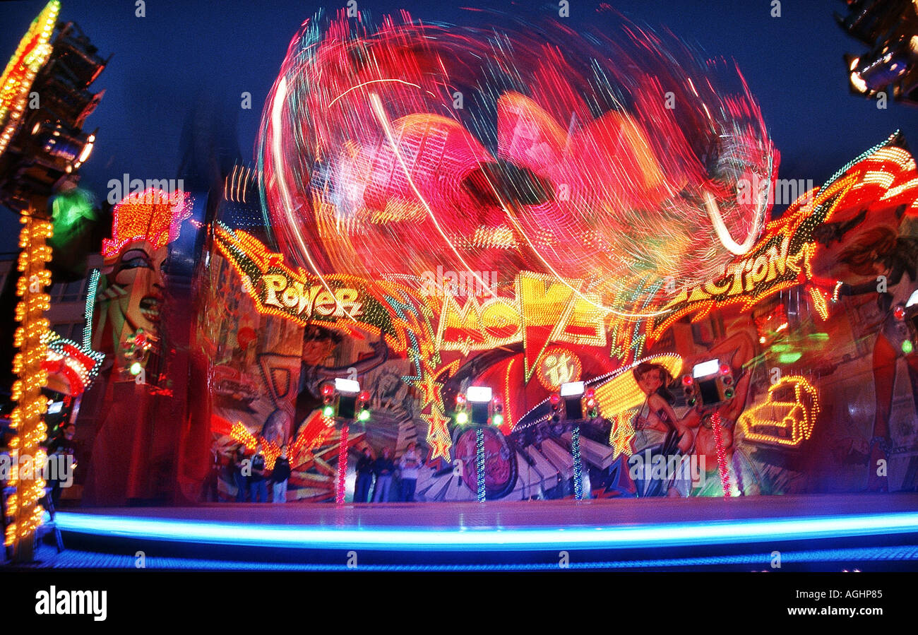 light streaks of fairground attraction in motion at dusk Stock Photo