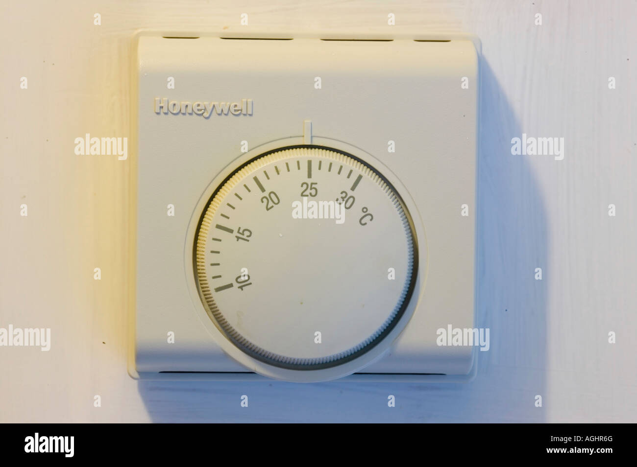 the central heating thermostat set to 25 degrees, too hot, wasting