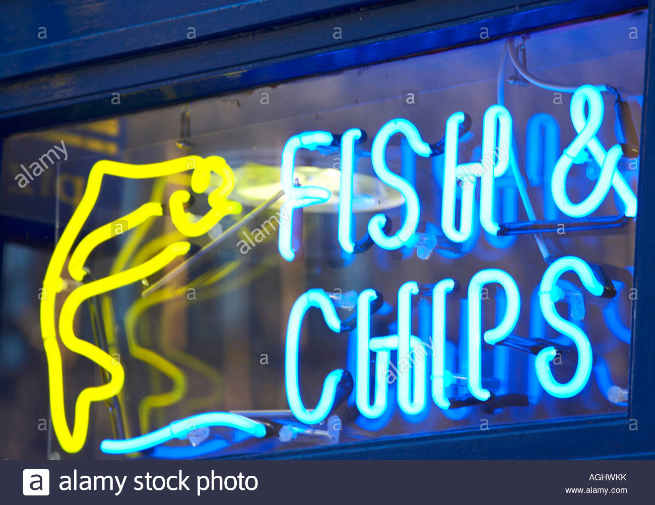Fish and chip shop neon sign in window Stock Photo