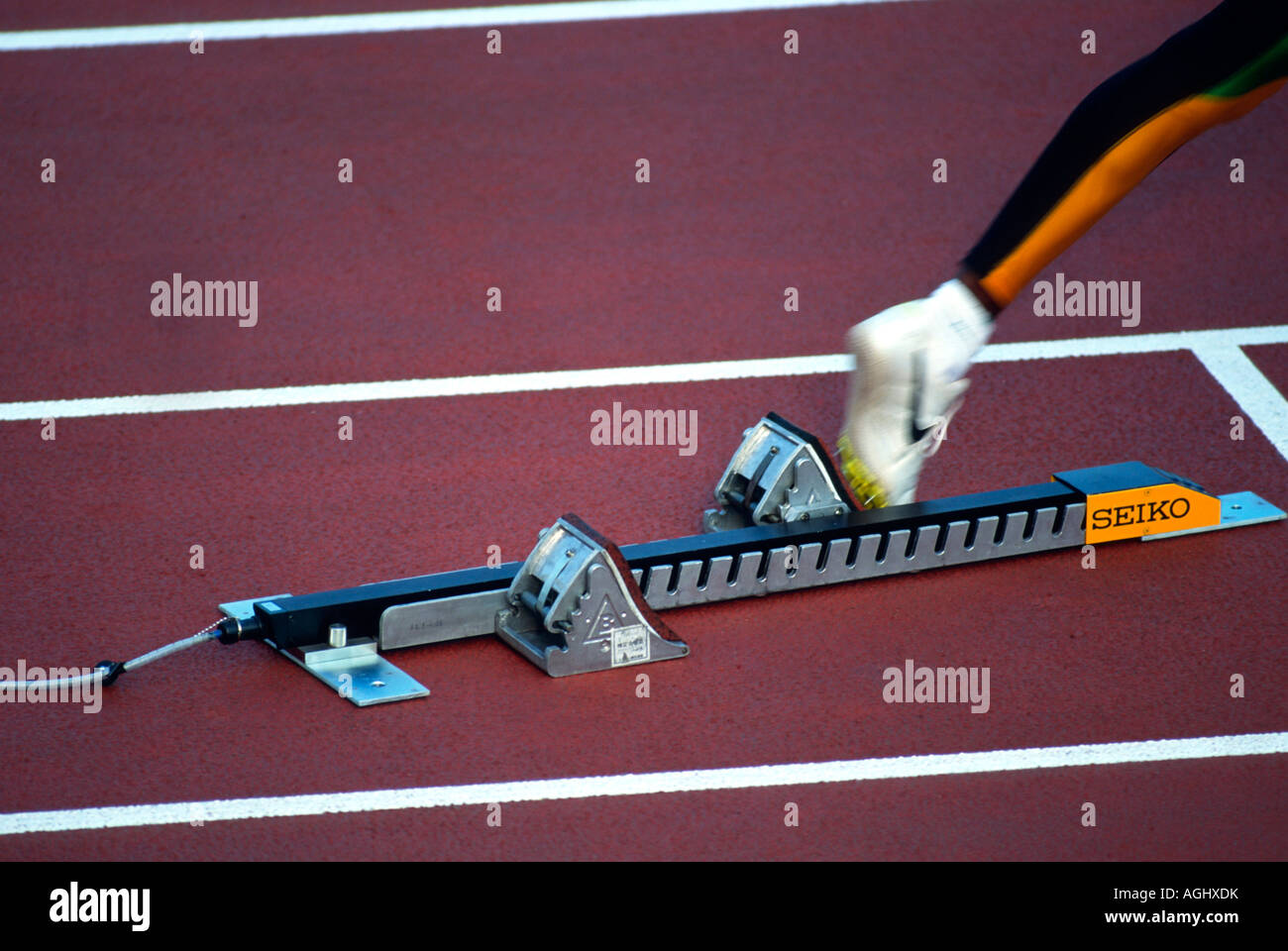 A track athlete prepares for the start of a 400M relay race Stock Photo