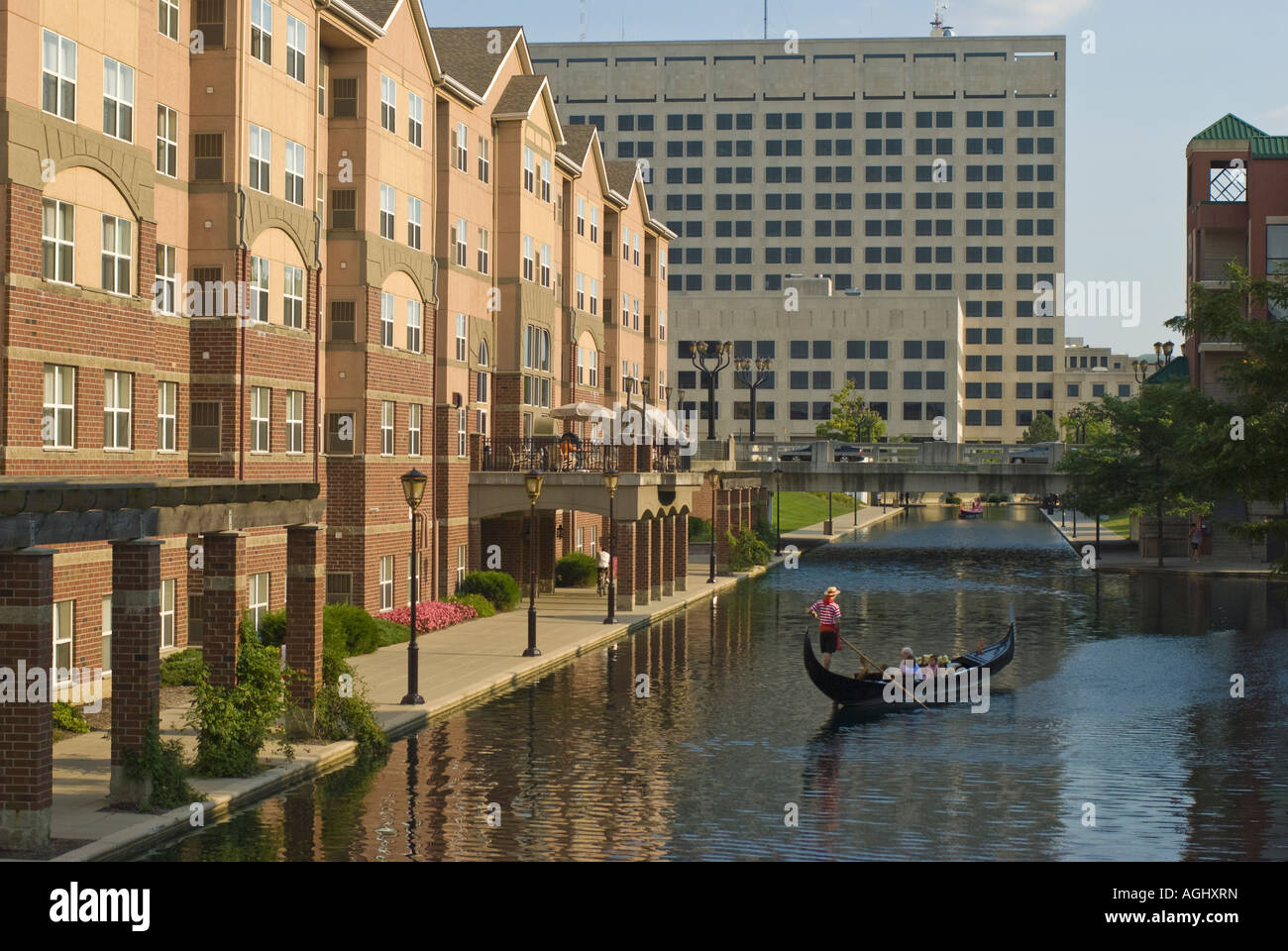 Tourists in Gondola with Man Steering on the Canal and White River