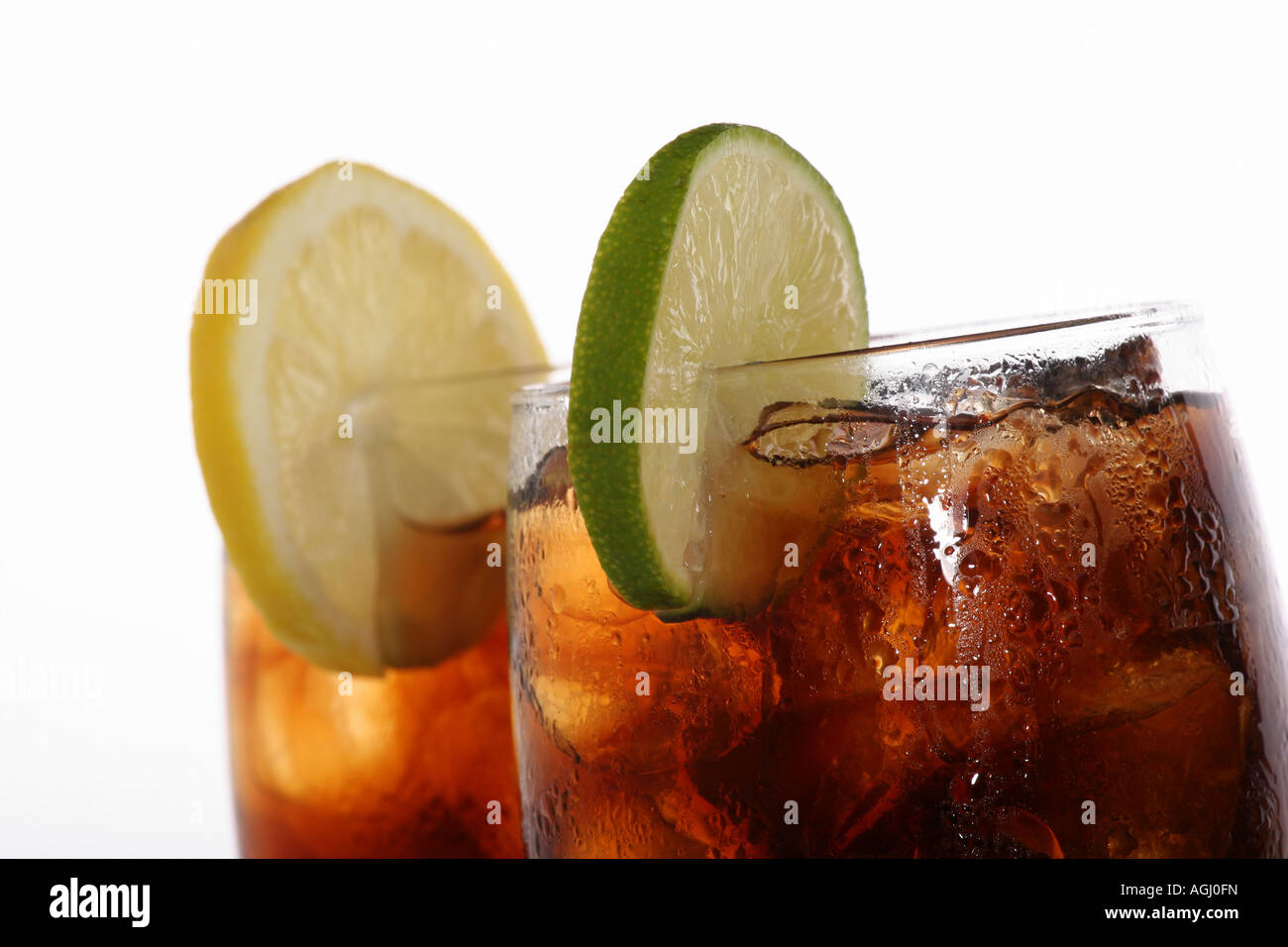 A glass of Coca Cola with ice cubes and a slice of green lime Coke soft ...