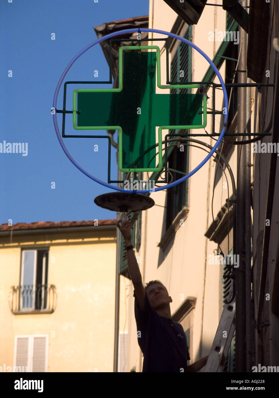 Man changing light bulb on ladder hires stock photography and images