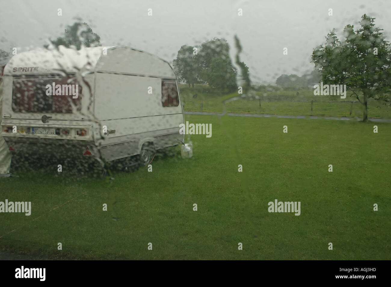 Small caravan parked up in wet caravan and camping park, Belcarra, near Castlebar, County Mayo, Republic of Ireland Stock Photo