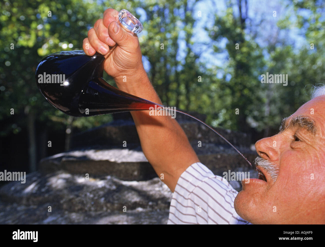 Traditional way of drinking wine from flask in Pyrenees Spain Stock Photo