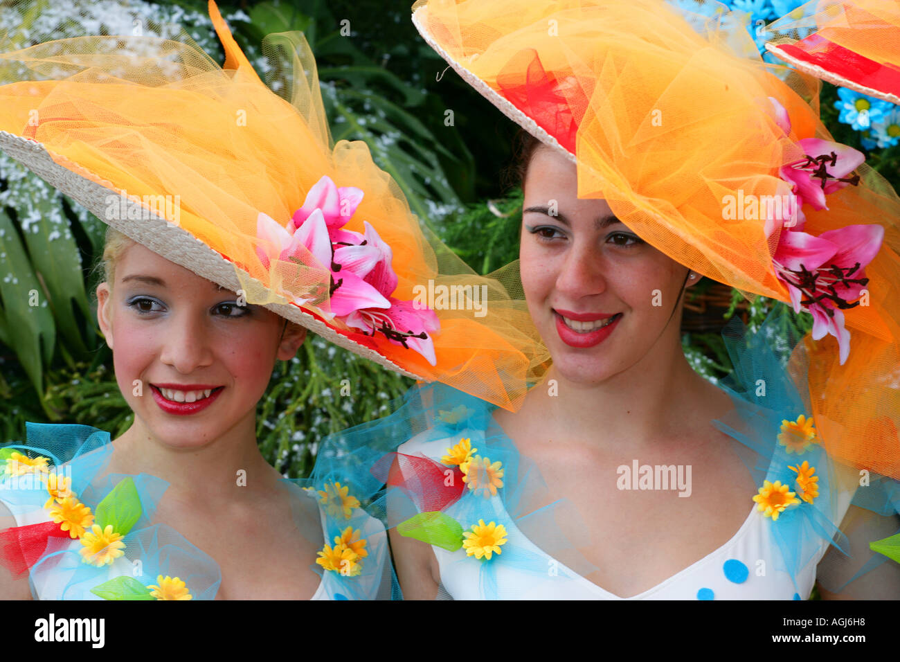 Two woman wearing colourful hats, Madeira Funchal Spring Flower Festival Stock Photo