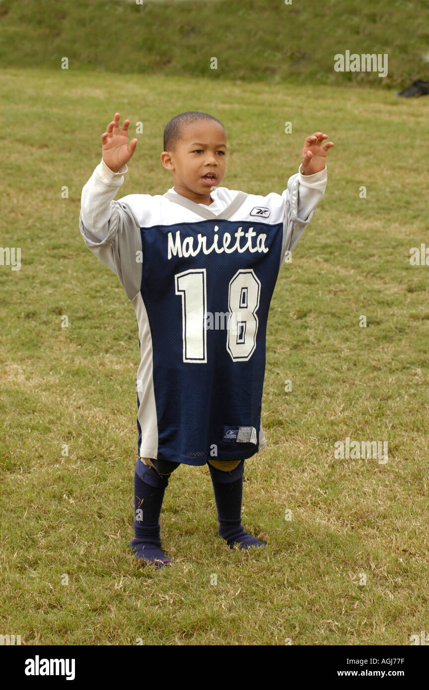 Young boy in large oversize football jersey Stock Photo - Alamy