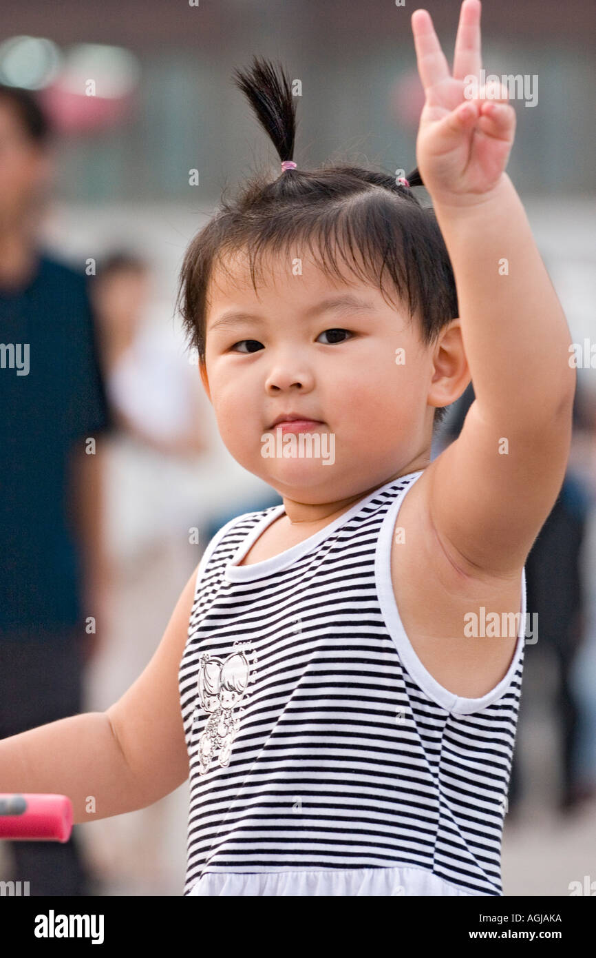 asia china xian little chinese girl shows victory sign Stock Photo