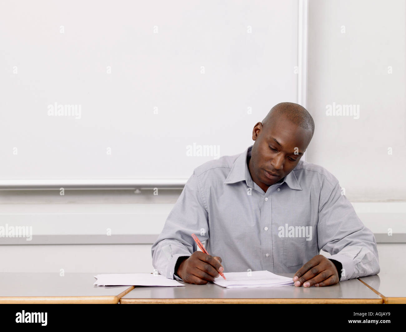 Teacher marking paperwork hires stock photography and images Alamy