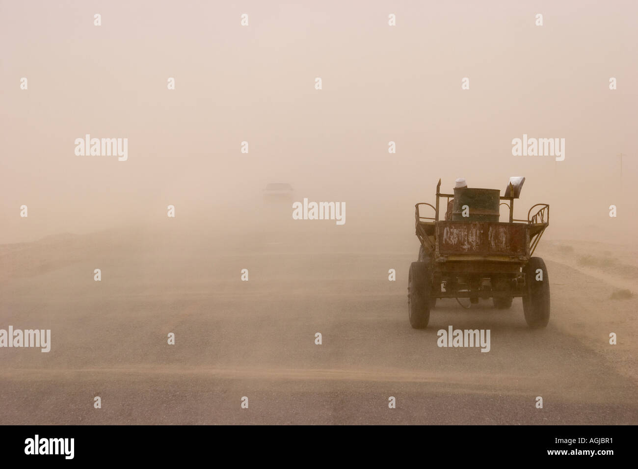 asia china vehicles in sandstorm on silkroad in the taklamakan desert Stock Photo