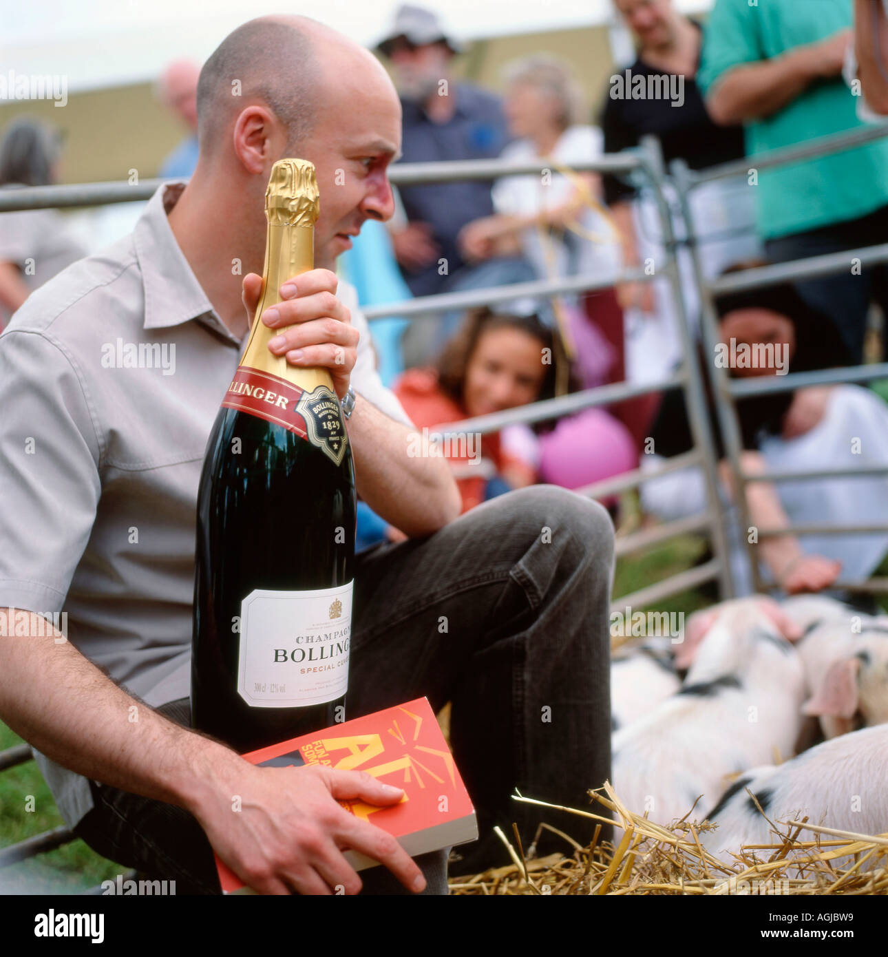 Author Christopher Brookmyre looking at his newly won pig at the 2006 Guardian Hay Festival Hay on Wye Wales UK Stock Photo