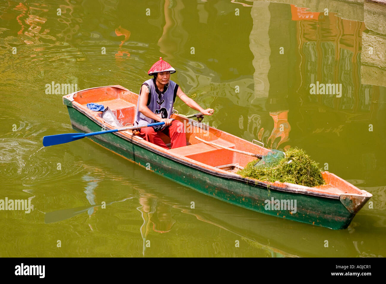 asia china chinese with sun shade in rowing boat in summer palace in beijing Stock Photo