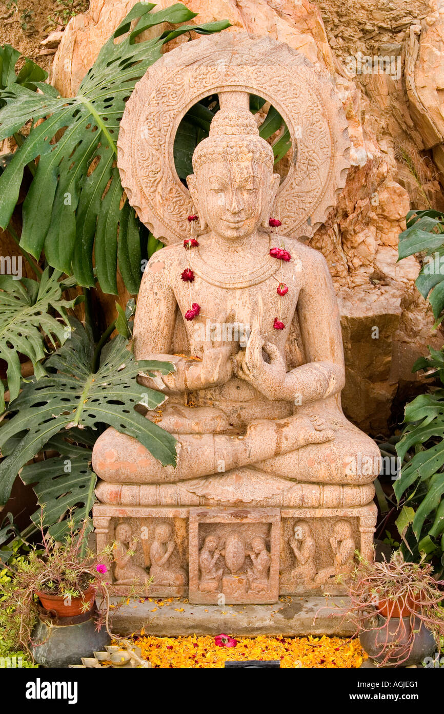 india buddha statue made of stone with flowerchain in udaipur rajasthan Stock Photo