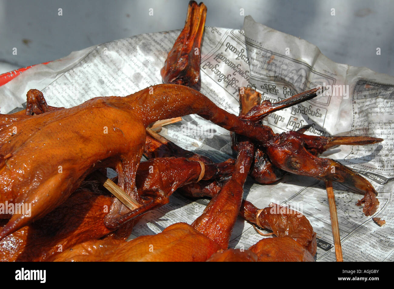 Yangon Myanmar roasted duck at a street food stall on local newspaper
