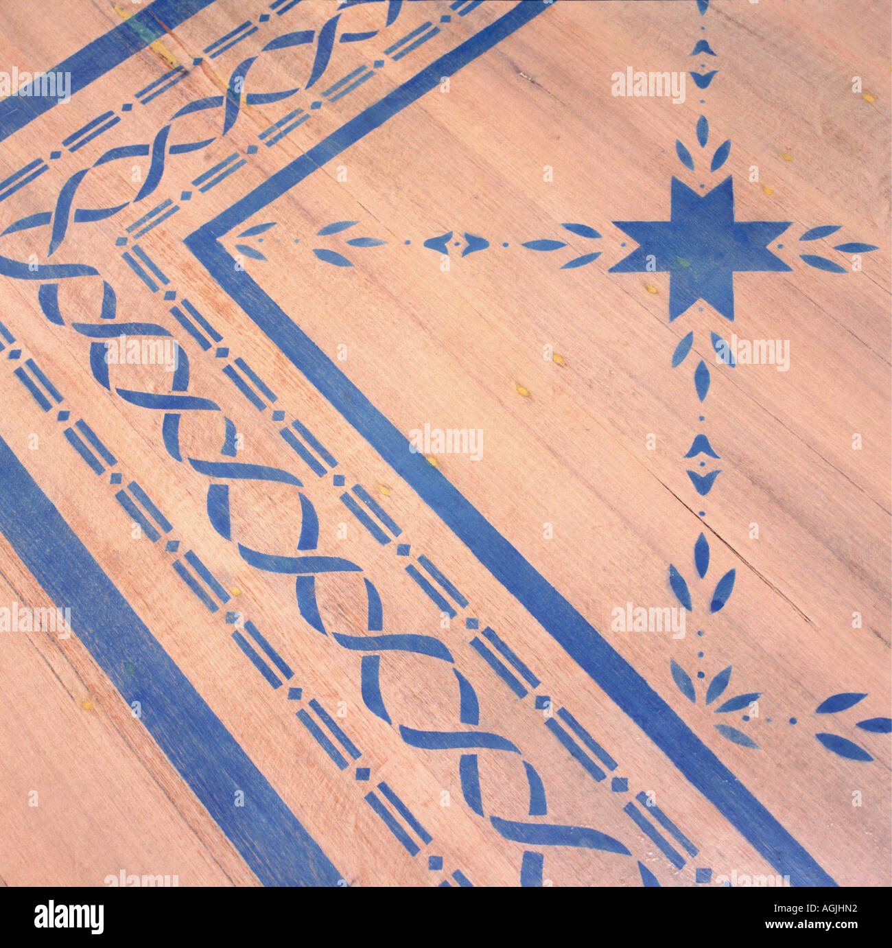 Close Up Of Wooden Floor With Blue Stenciled Pattern Stock Photo