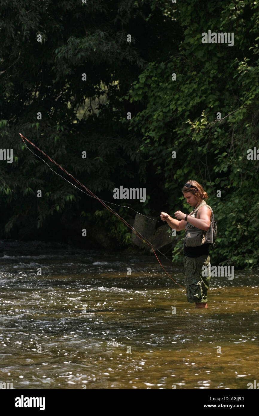 fisherman fly fishing on river Manistee in Michigan MI USA Stock Photo