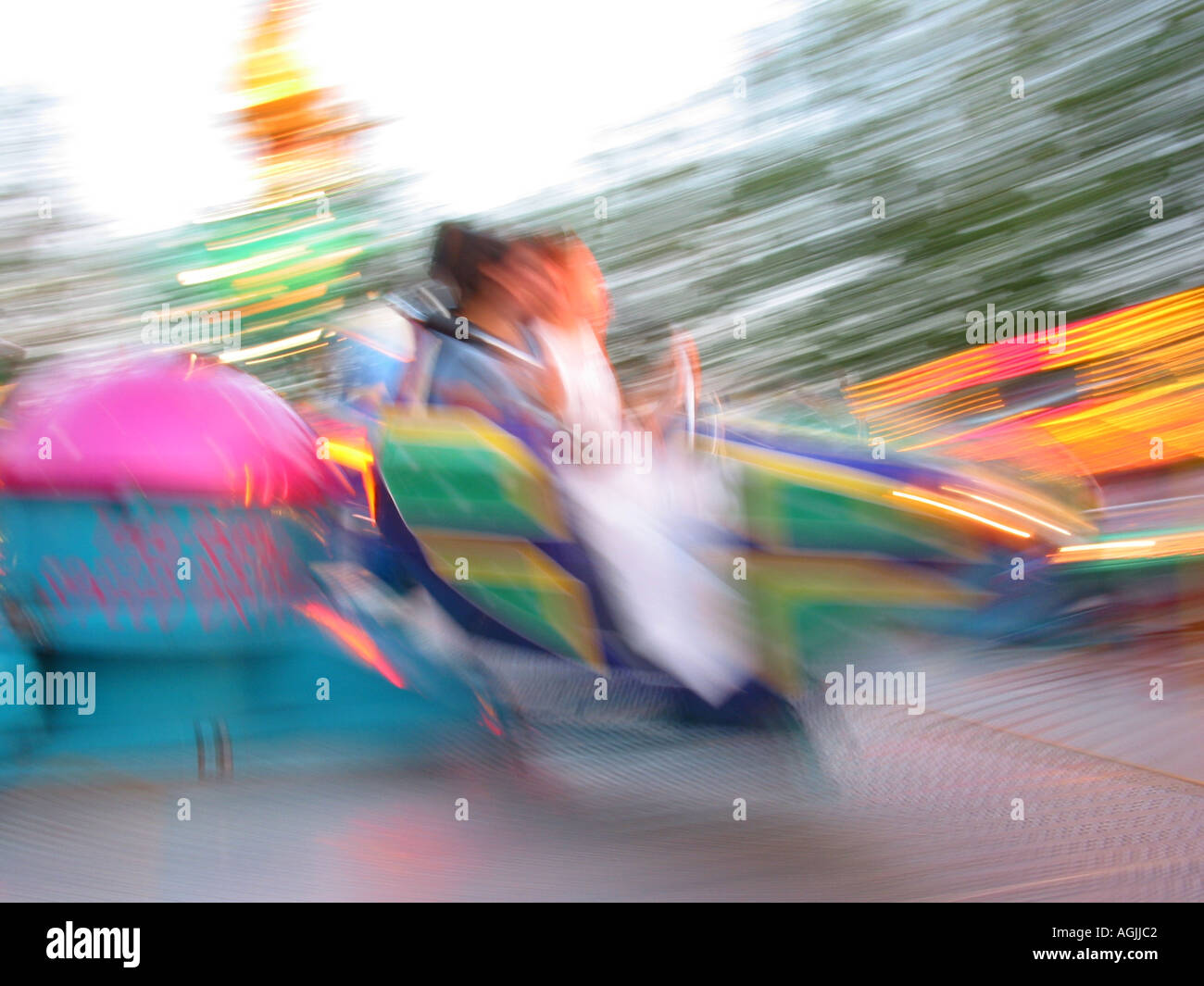 colourful fairground ride in motion with blurred passengers Stock Photo ...