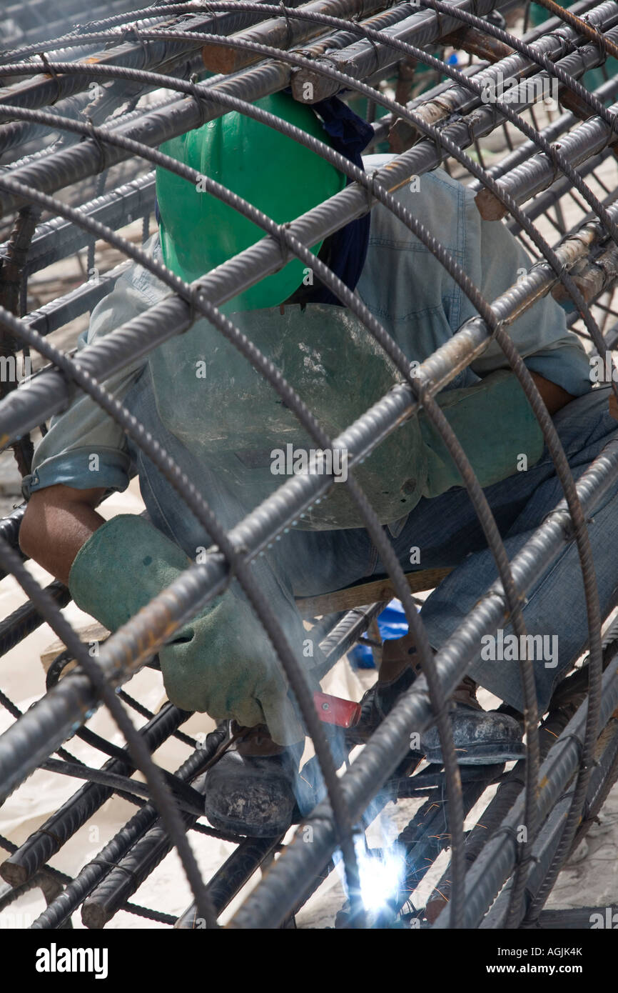welder working on rebar for reinforced concrete on a construction site ...