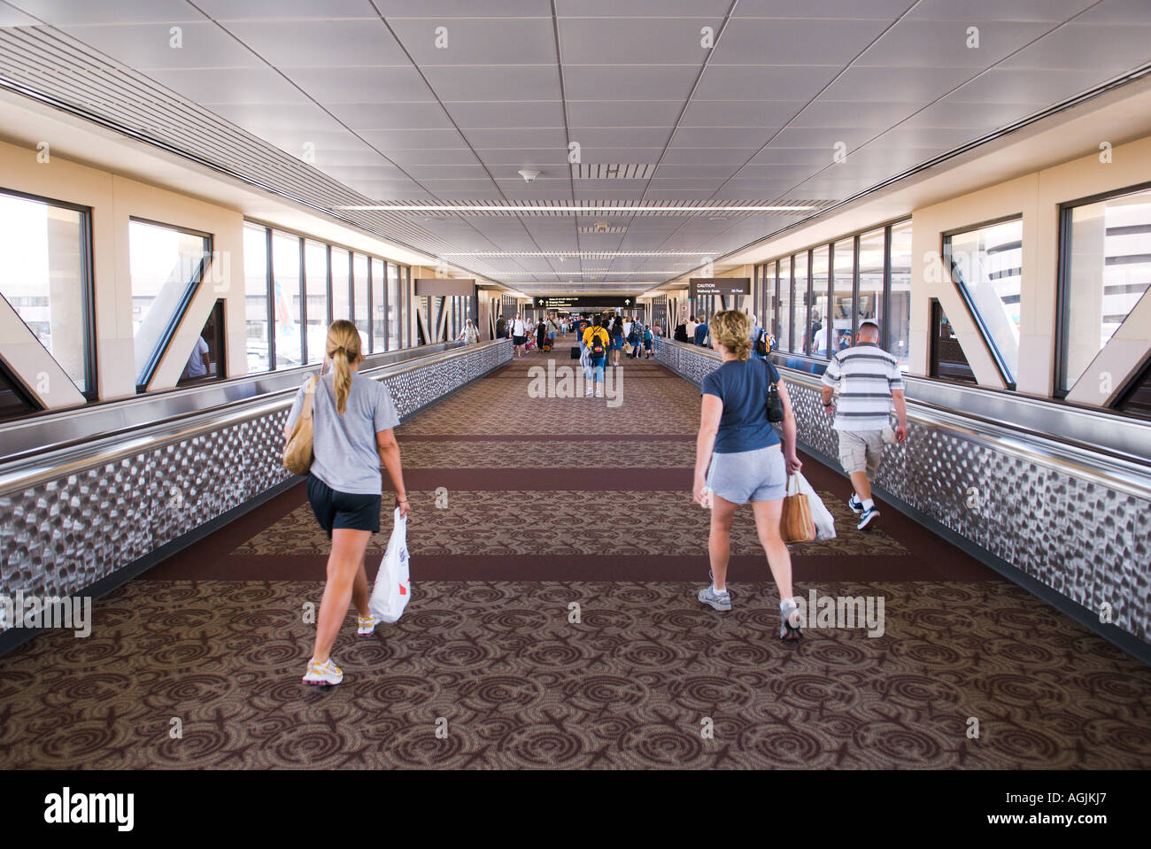 Passengers take the long walk between terminals at the Phoenix Airport