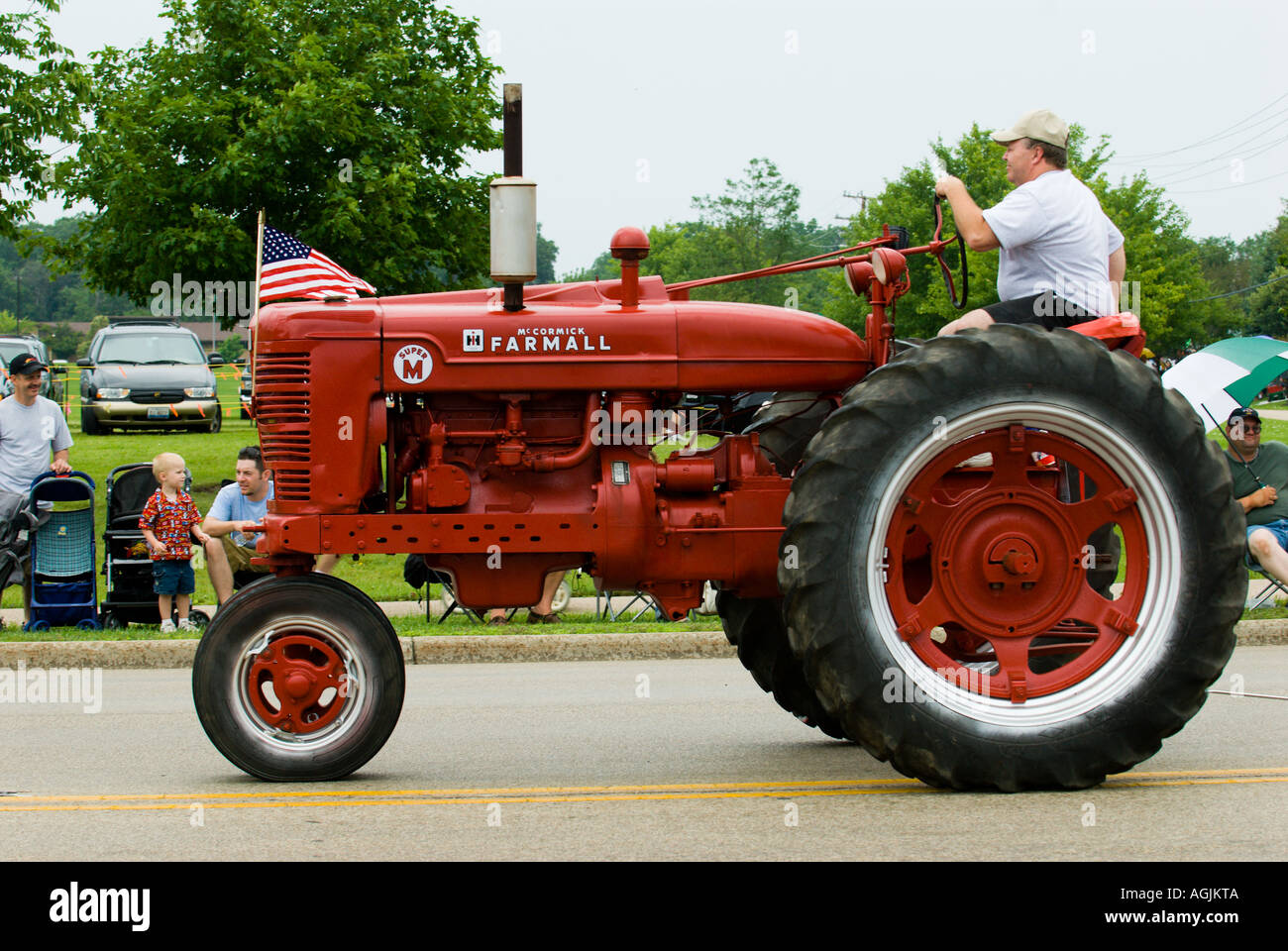 Red tractor in a 4th of July parade in Bartlett Illinois with an