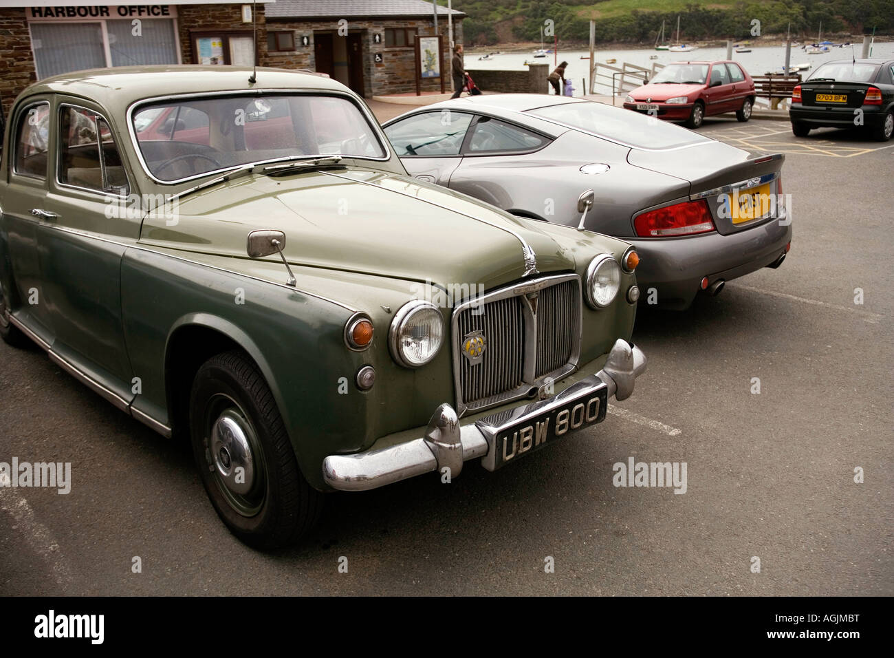 UK Devon Salcombe Normandy Way Rover 100 parked next to Aston Martin Vantage Stock Photo