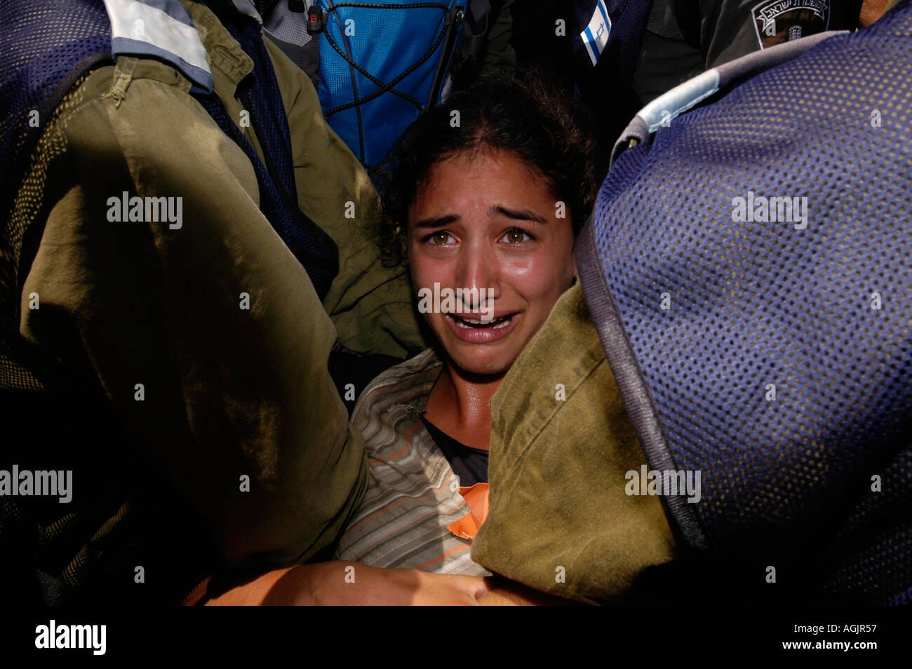 A Jewish girl reacts as Israeli police and soldiers remove settlers from Tel Katifa settlement as part of the Israeli disengagement from Gaza strip Stock Photo