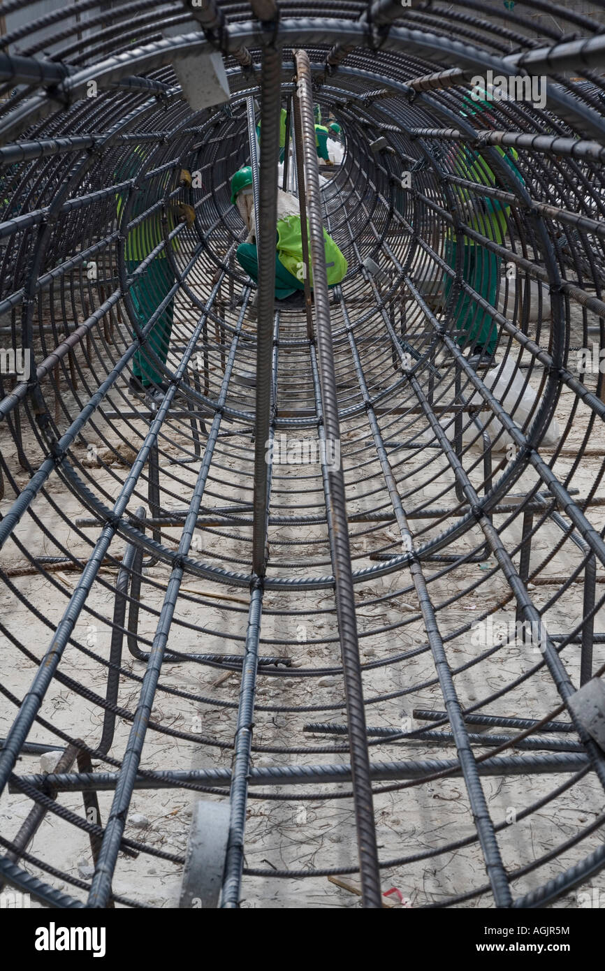 workers preparing rebar circular cage frame for reinforced concrete