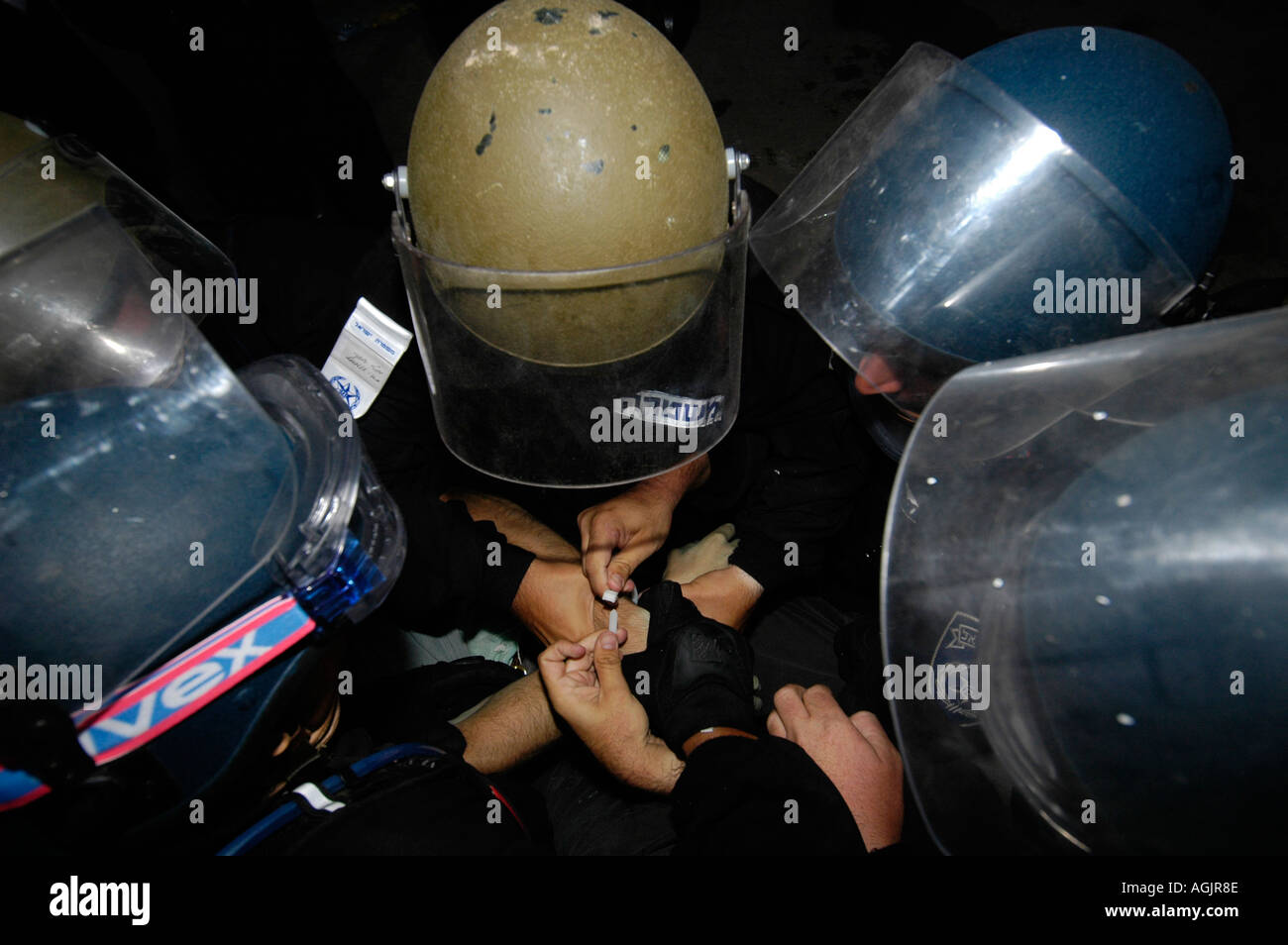 Police officers arresting a young Jewish settler during Jewish settlements evacuation from Gaza strip. August 2005 Stock Photo