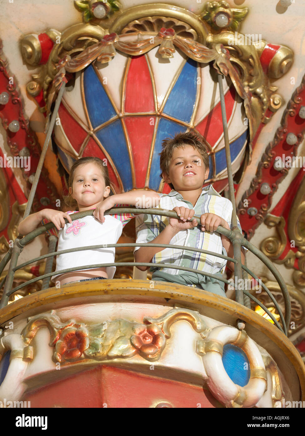 Brother and sister on a fairground ride Stock Photo