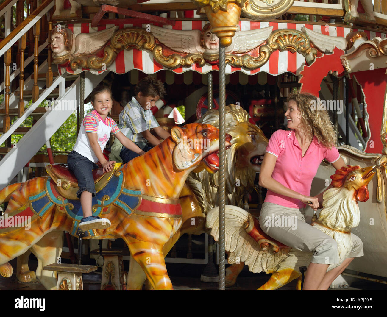 Mother and kids on a carousel Stock Photo Alamy