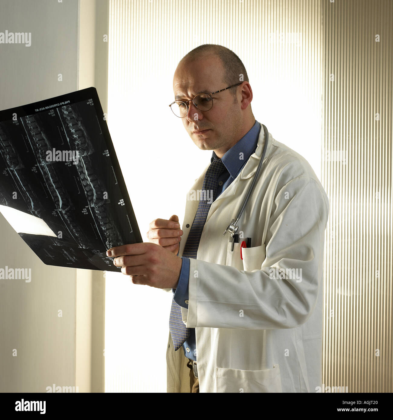 Doctor looking at x ray picture Stock Photo - Alamy