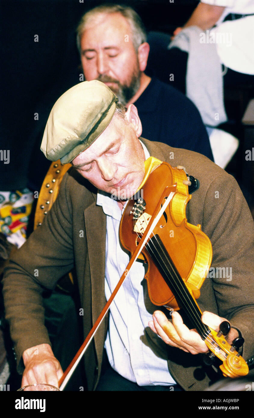 Traditional Irish pub music session in Days Bar on County Galway island of Inishbofin. Des O’Halloran, singer and fiddle player. Stock Photo