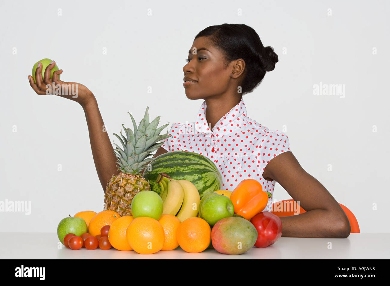 Young woman holding an apple Stock Photo