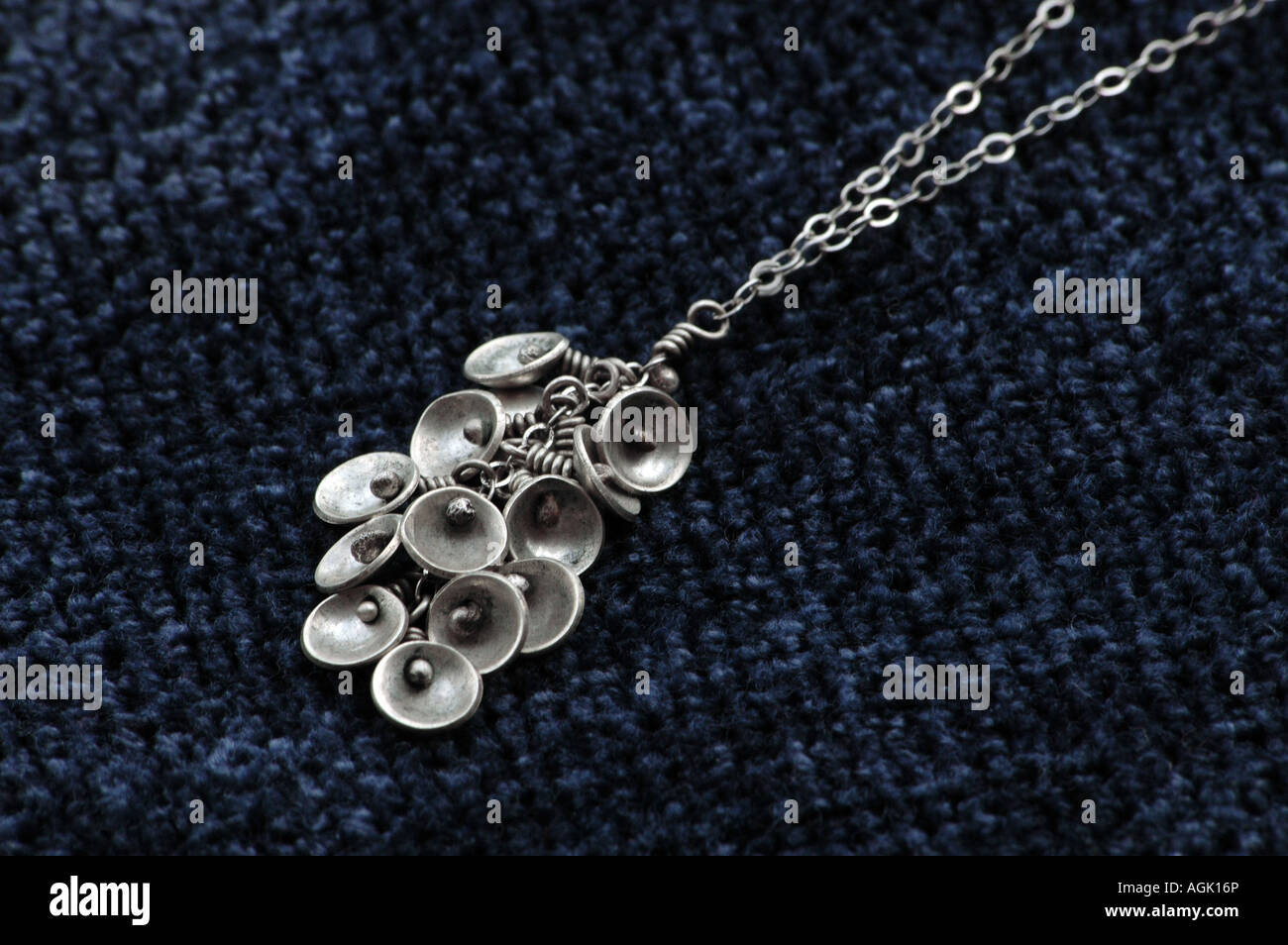 Necklace made of domed sterling discs laid on a cushion. Stock Photo