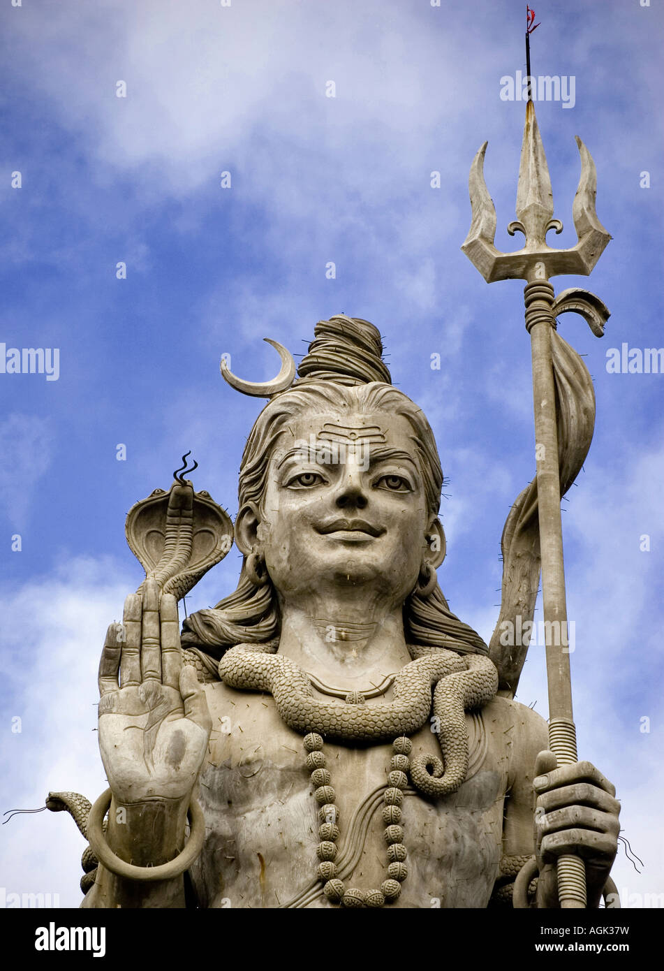 front view head shot of a statue of the hindu divinity Lord Shiva and his trident Stock Photo