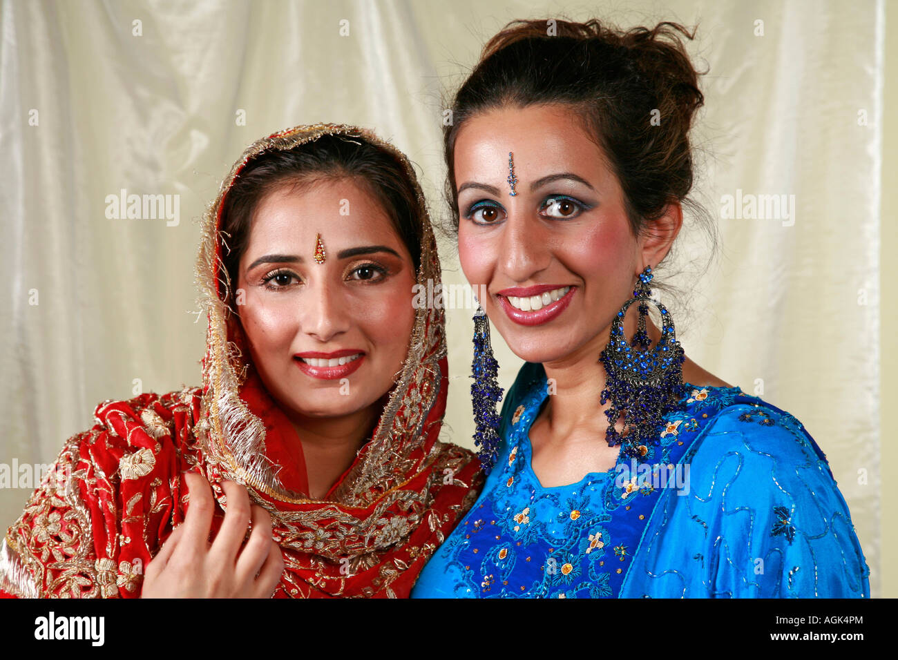 Asian women in Traditional Indian Wedding Dresses with jewellery, earrings, tikka and bindi Stock Photo