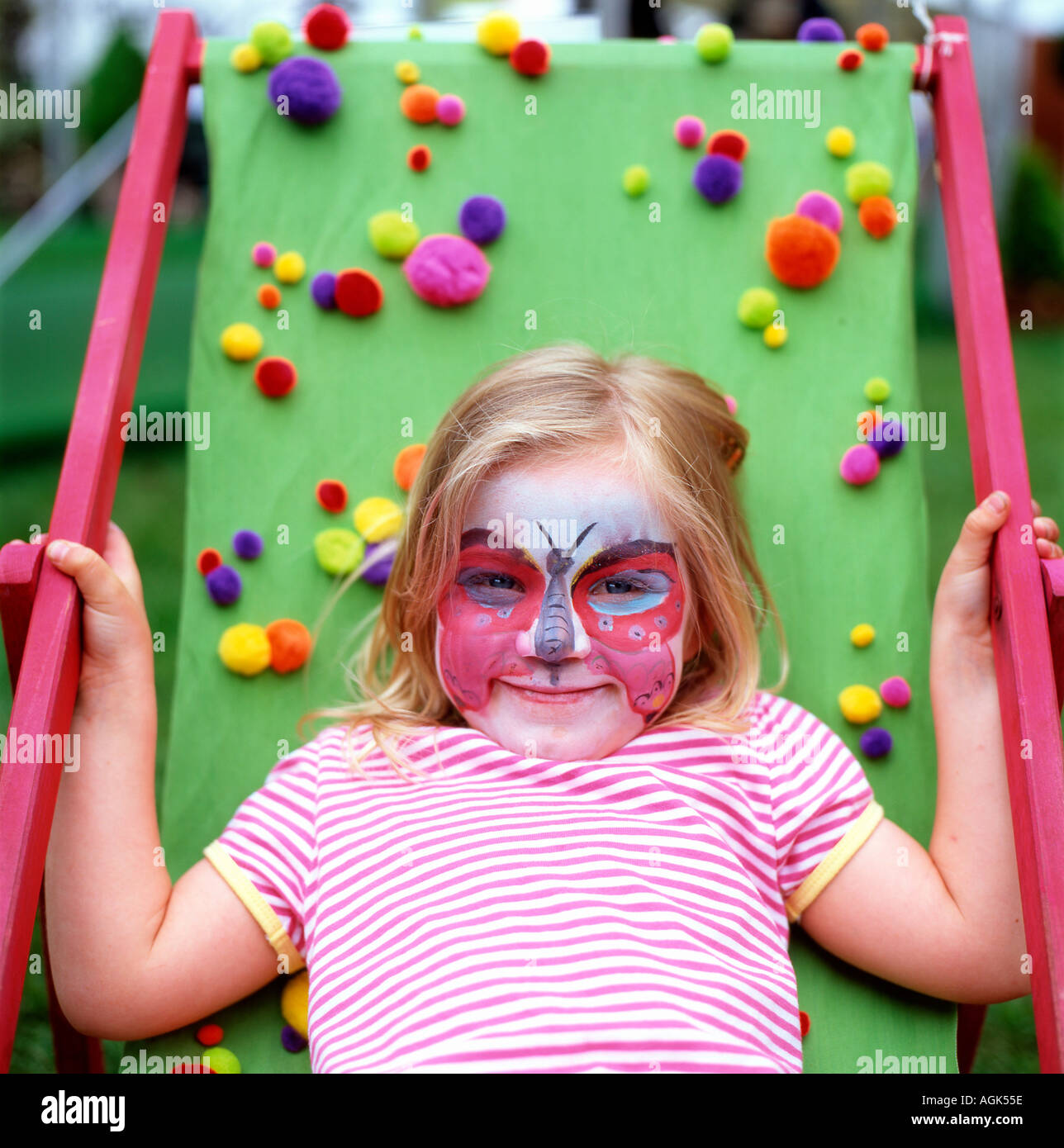 Child with dragonfly face painting at the Guardian Hay Festival, Wales